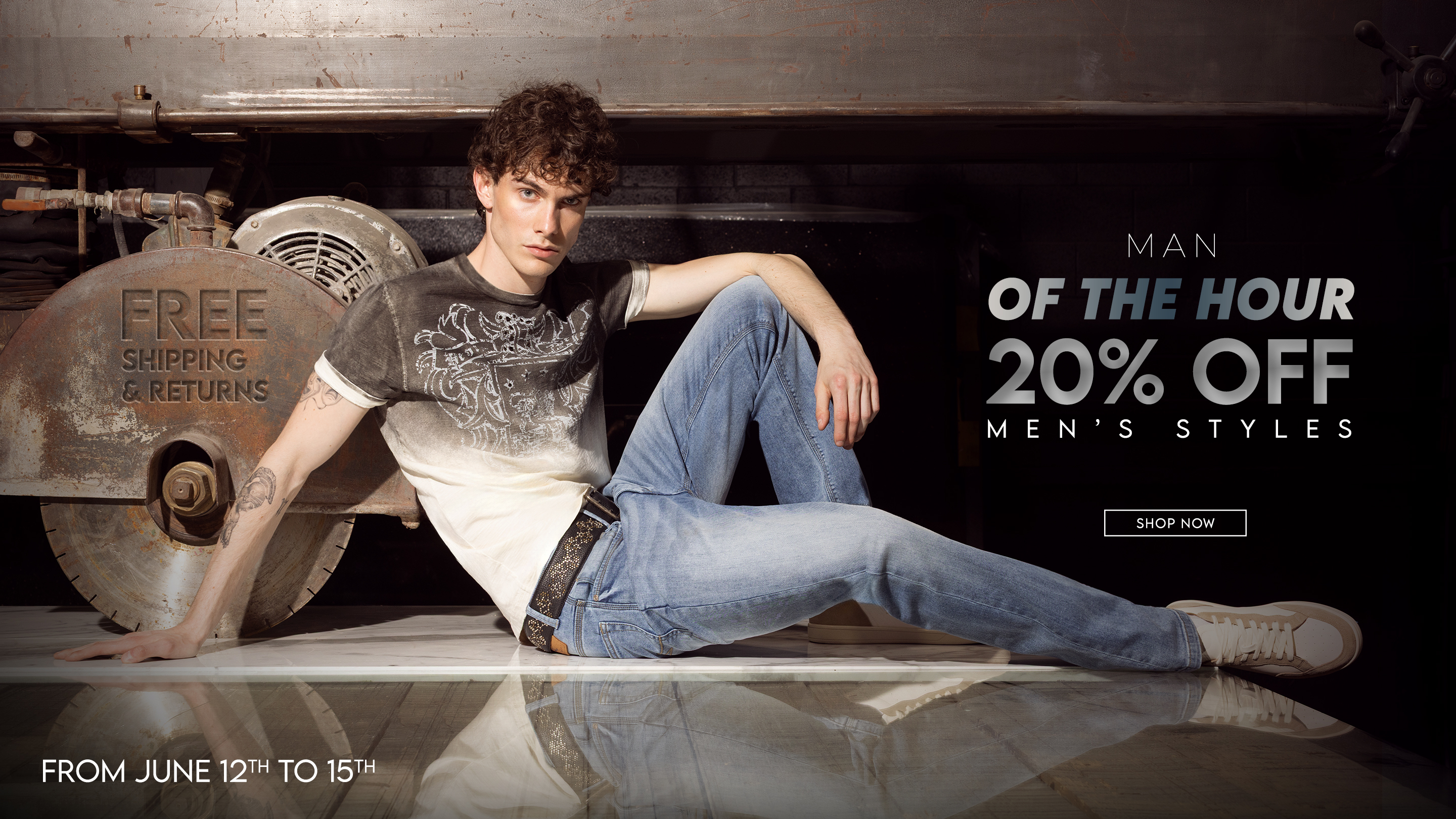 Attractive man wearing a blue archival top from the 1990s and light wash denim jeans.