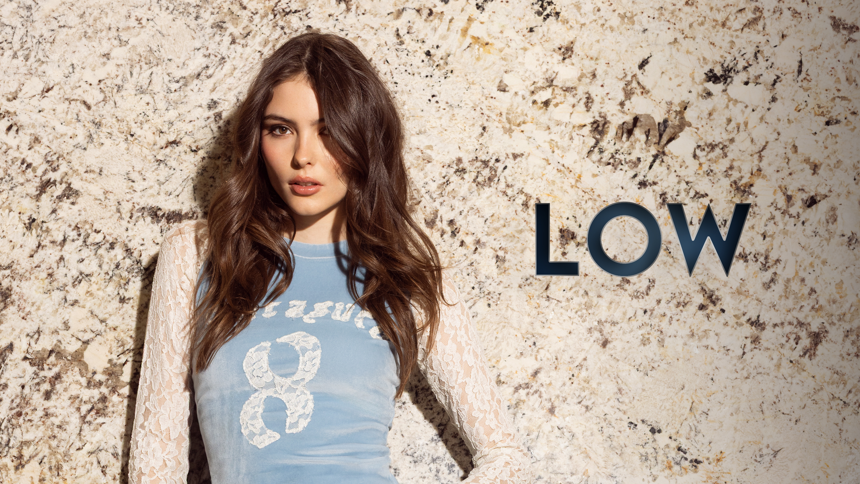 Descriptive text: Low. Woman wearing archival blue top from 1990s.