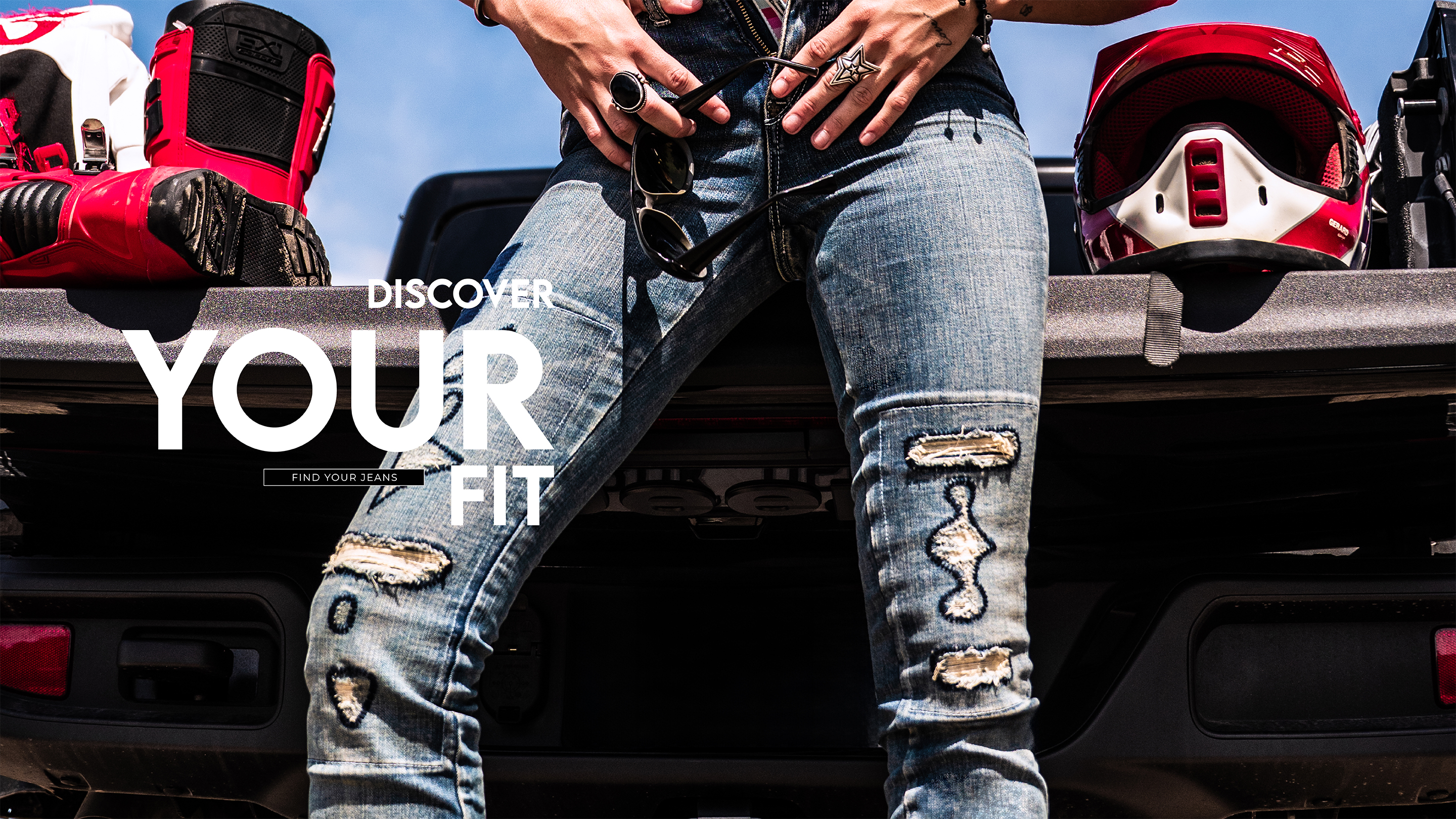 Large banner divided into three sections, 2/3. Showcasing different styles of men’s jeans. Text on image: “Find Your Fit.” Invitation to explore our range of men’s jean fits.